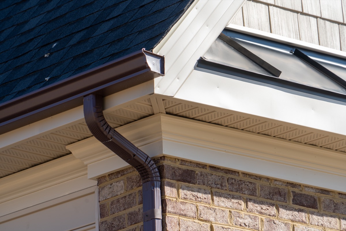 Gutter and downspout on white fascia